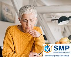 Picture of lady reviewing paper work with the SMP logo